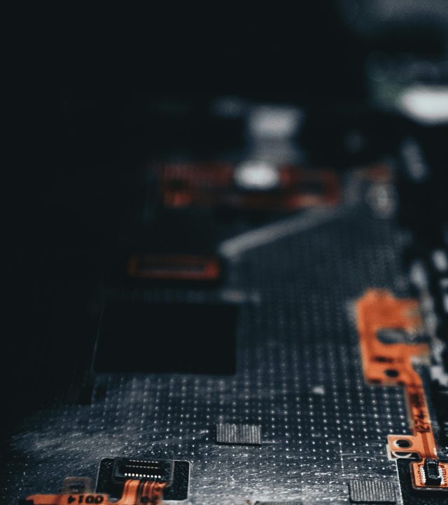 pexels-photo-2182863-2182863 Close-up of a dark circuit board showcasing electronic components and connections.